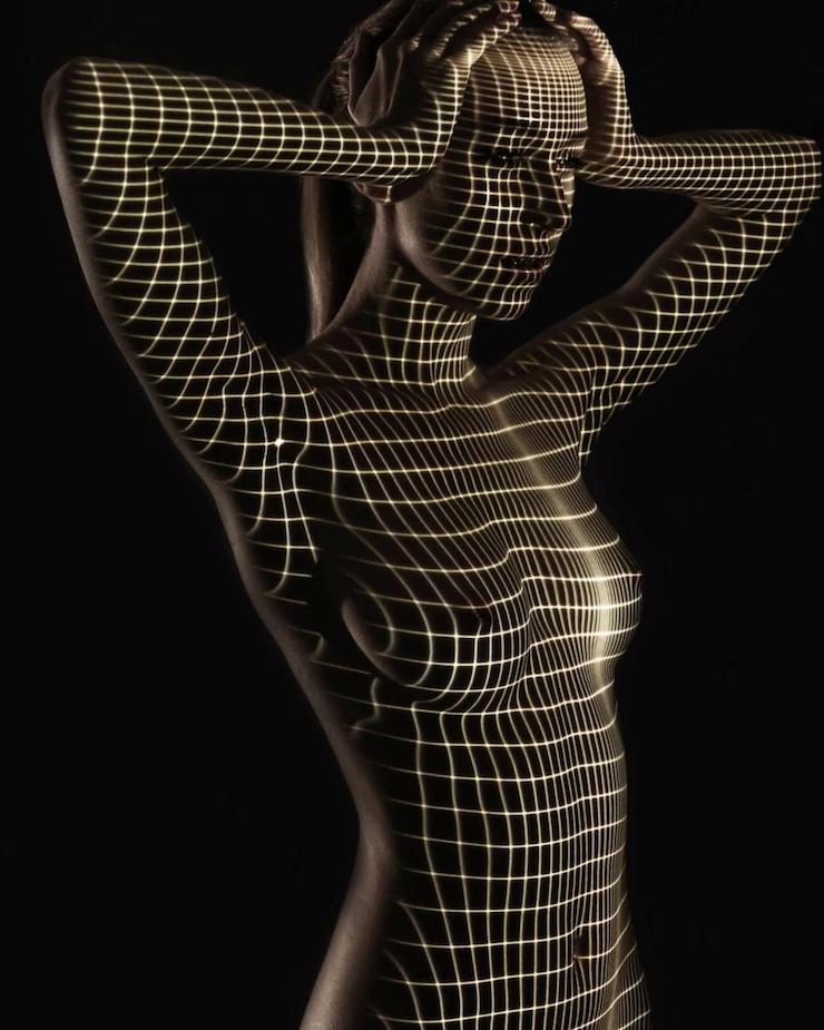 Un photographe habille des femmes dévêtues d’ombres et lumière colorée